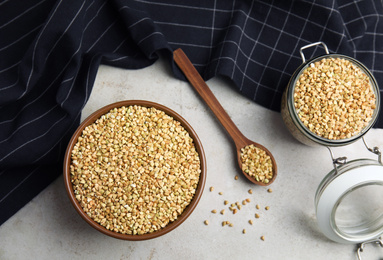 Photo of Uncooked green buckwheat grains on table, flat lay