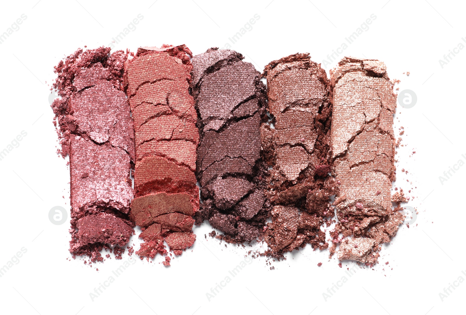 Photo of Different crushed eye shadows on white background, top view. Professional makeup product