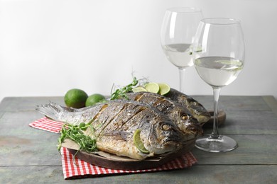 Photo of Seafood. Delicious baked fish served on rustic wooden table, space for text