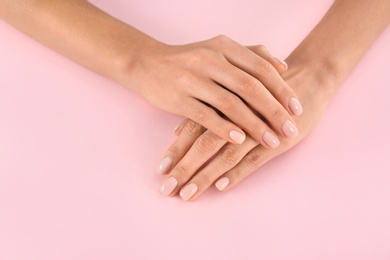 Closeup view of woman with beautiful hands on color background. Spa treatment