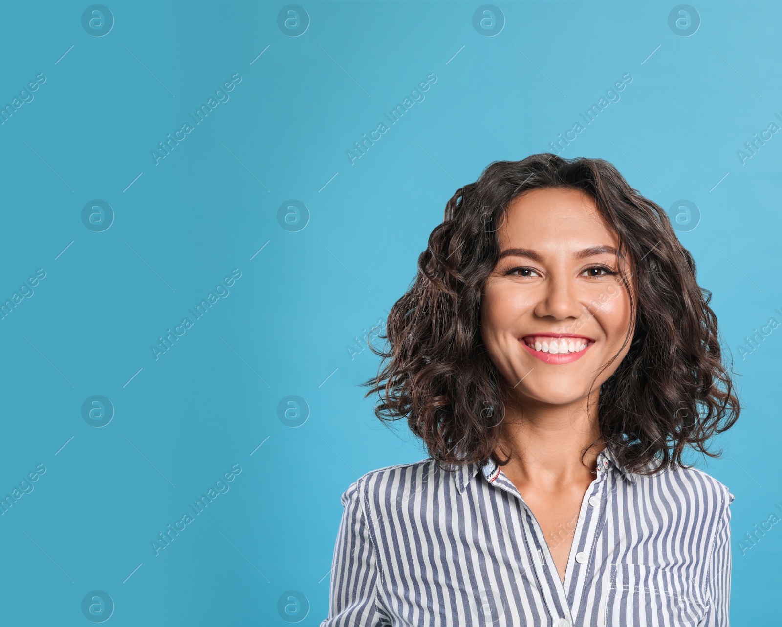 Photo of Happy young woman in casual outfit on blue background. Space for text