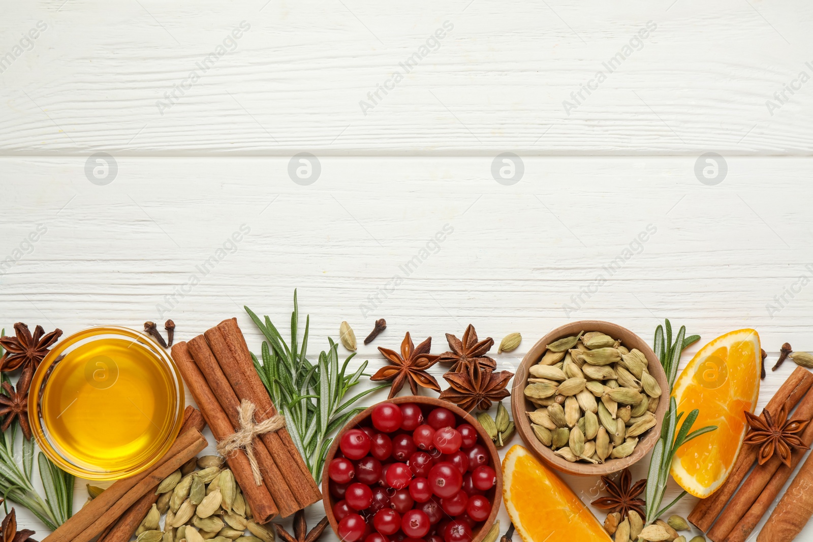 Photo of Flat lay composition with mulled wine ingredients on white wooden table. Space for text