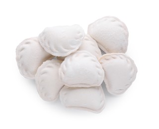 Pile of raw dumplings (varenyky) on white background, top view