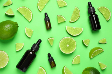 Photo of Flat lay composition with lime essential oil on green background