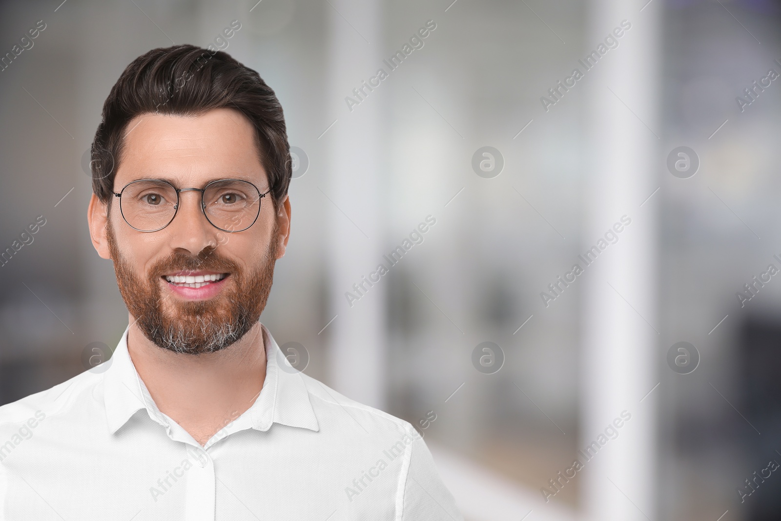 Image of Handsome confident man with eyeglasses in office, space for text