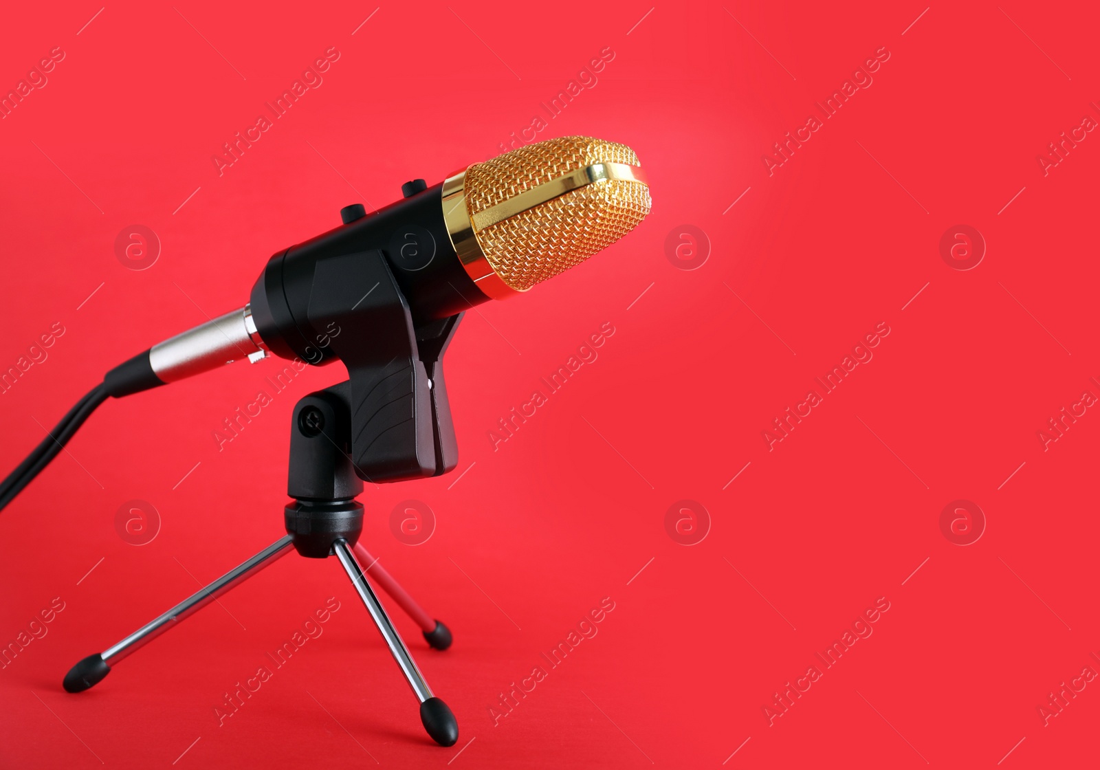 Photo of Condenser microphone on color background, space for text