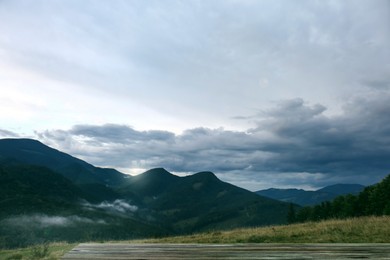 Image of Empty wooden surface and picturesque viewcloudy sky over majestic mountain landscape