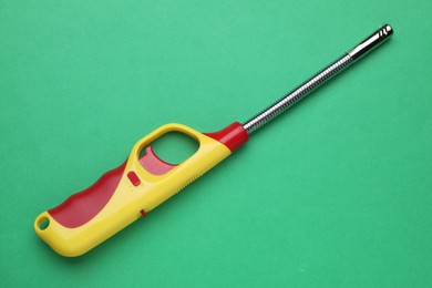 One gas lighter on green background, top view