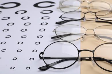 Vision test chart and glasses on table, closeup