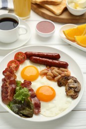 Photo of Delicious breakfast with sunny side up eggs on white wooden table