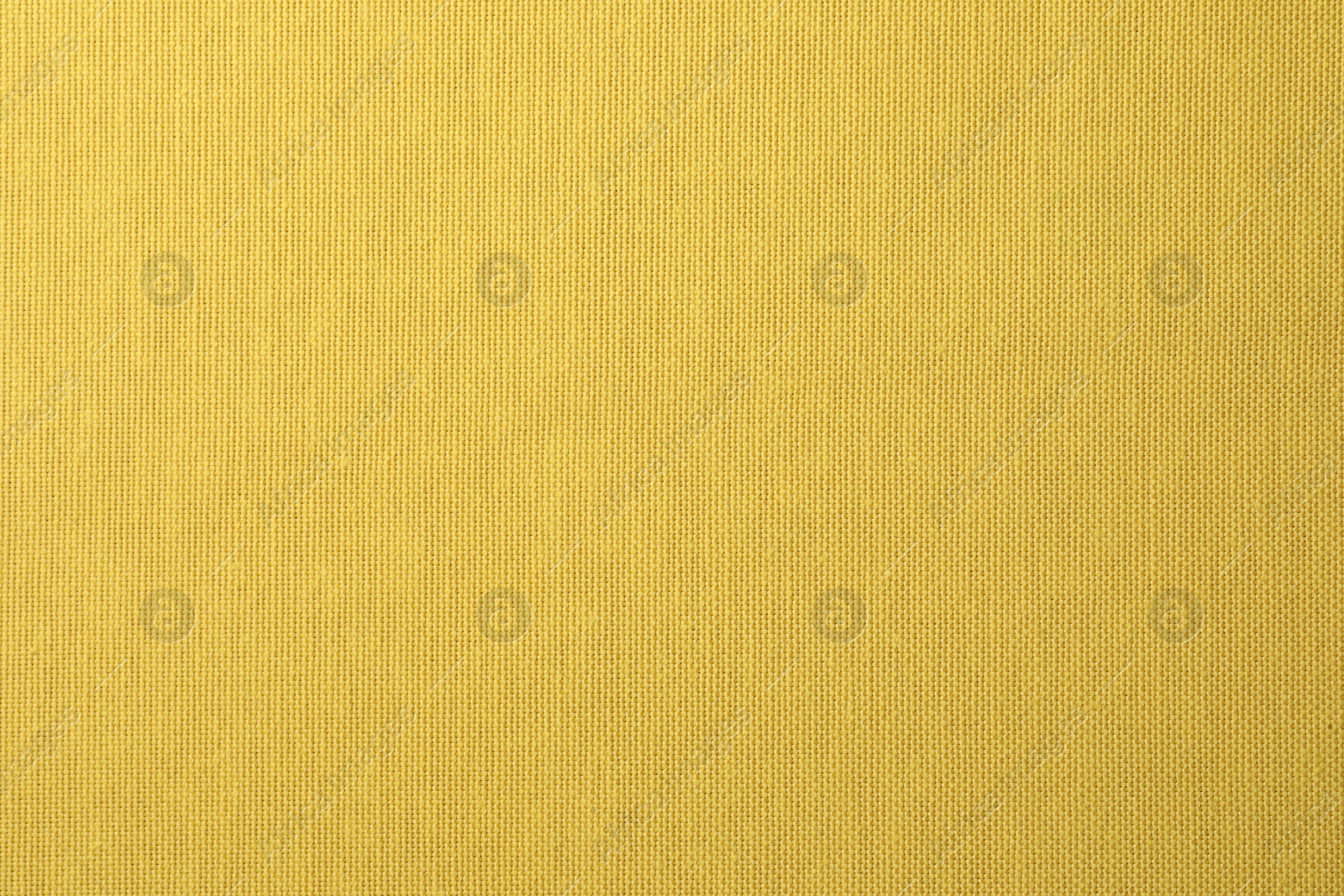 Photo of Texture of yellow fabric as background, top view