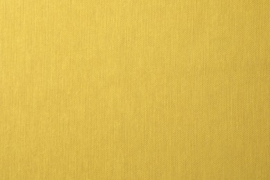 Photo of Texture of yellow fabric as background, top view