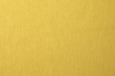 Texture of yellow fabric as background, top view