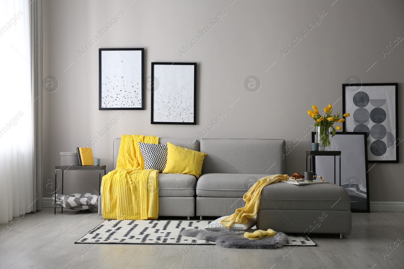 Photo of Stylish living room interior with comfortable sofa. Interior design in grey and yellow colors