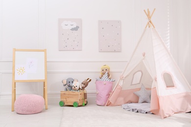 Cute child's room interior with toys, modern furniture and play tent