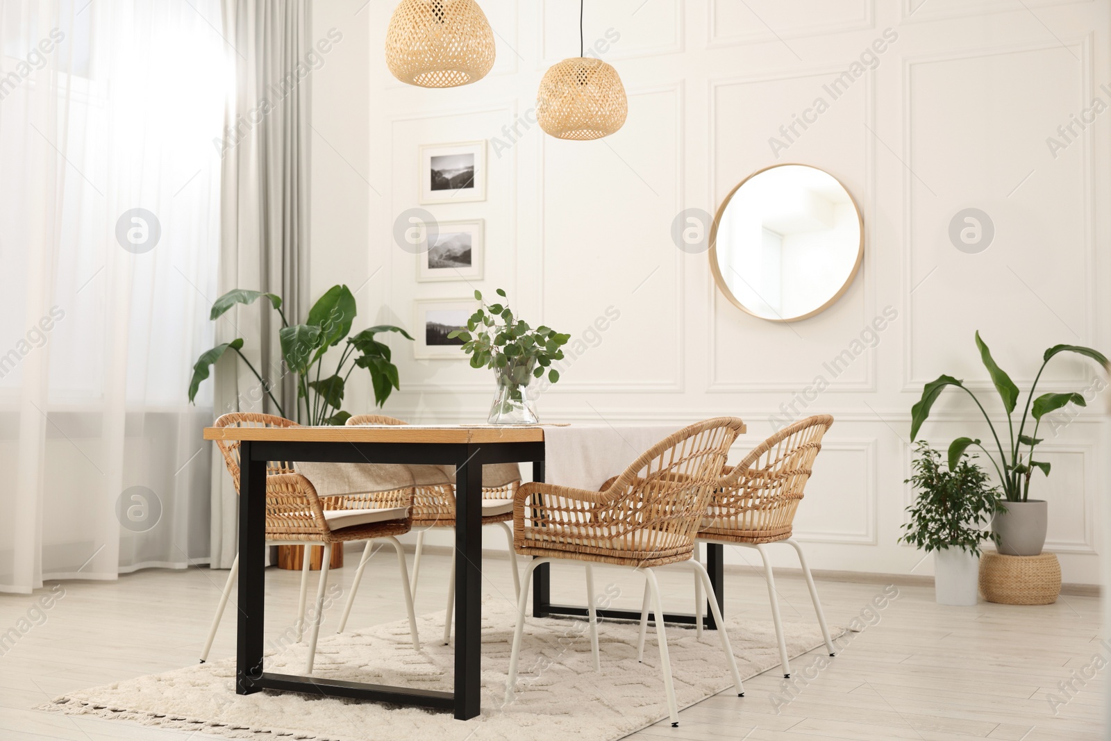 Photo of Stylish dining room with cozy furniture, mirror and plants