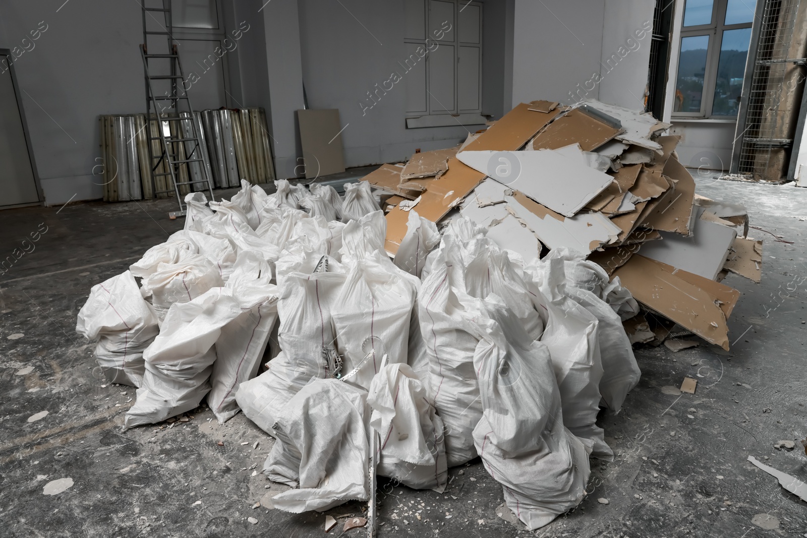 Photo of Used and new building materials in room prepared for renovation