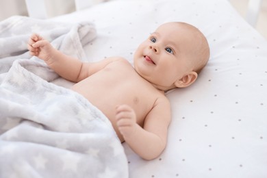 Photo of Cute little baby lying in crib at home