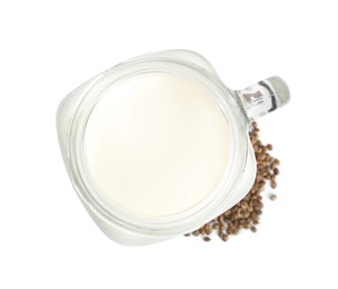 Mason jar of fresh hemp milk and seeds on white background, top view