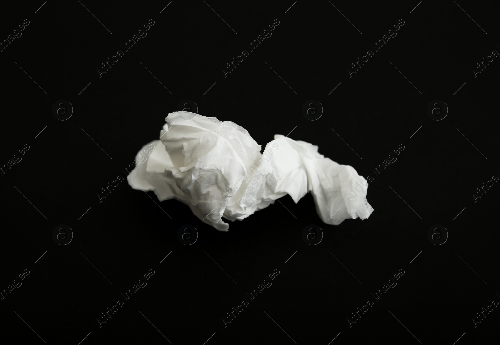 Photo of Used white paper tissue on black background