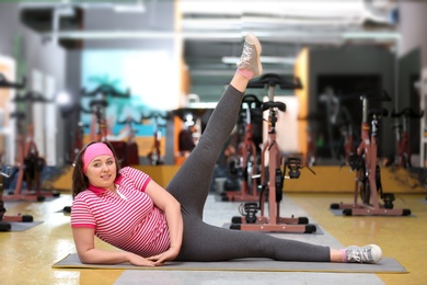 Photo of Overweight woman doing exercise in gym