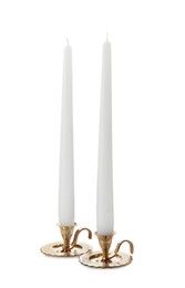 Elegant candlesticks with candles on white background