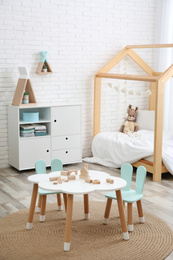 Cute children's room interior with bed and little table