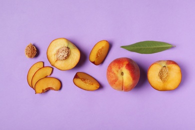 Photo of Flat lay composition with sweet juicy peaches on lilac background