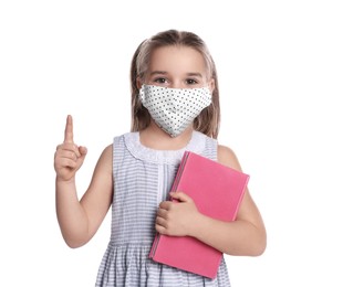 Little girl wearing protective mask with book on white background. Child safety