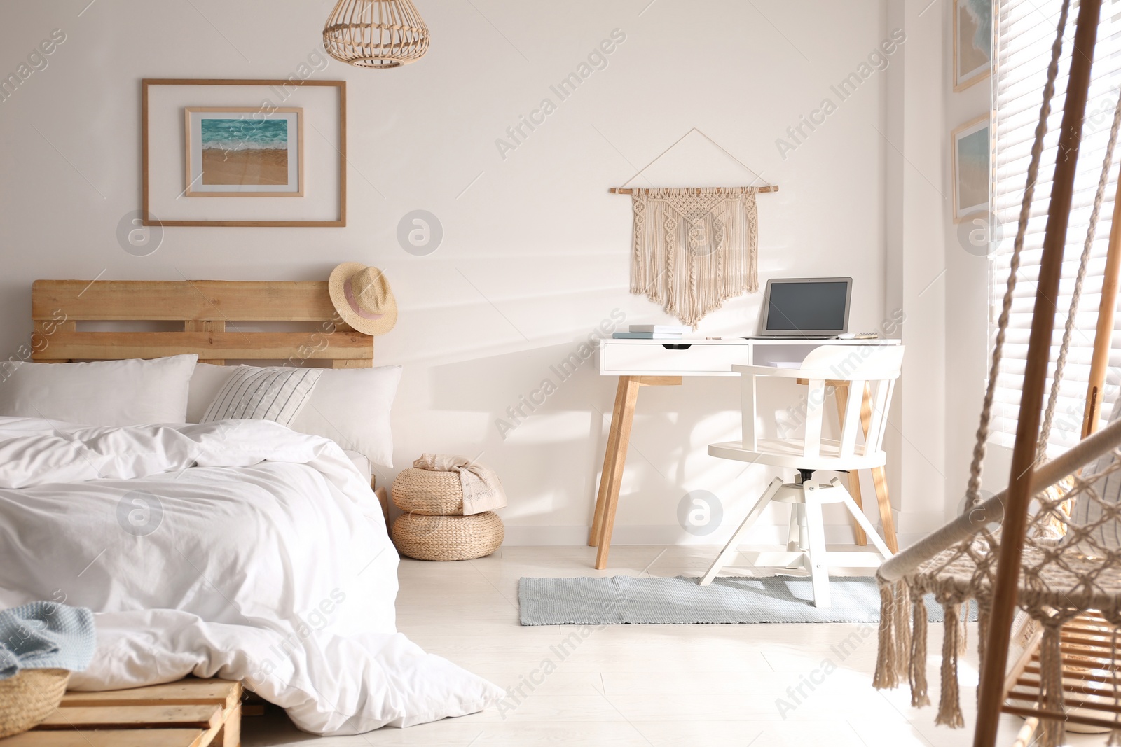 Photo of Stylish room interior with workplace and bed