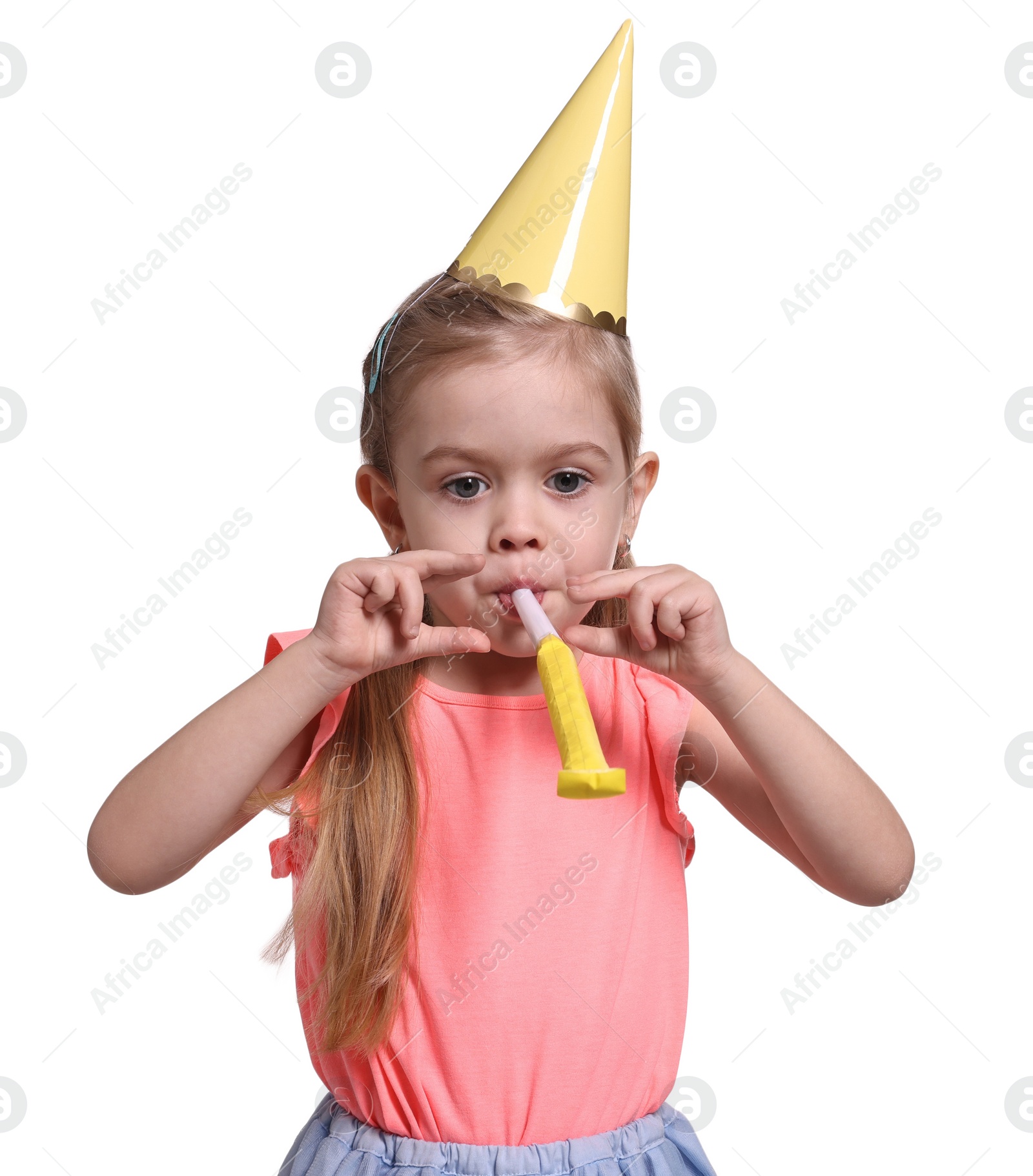 Photo of Birthday celebration. Cute little girl in party hat with blower on white background