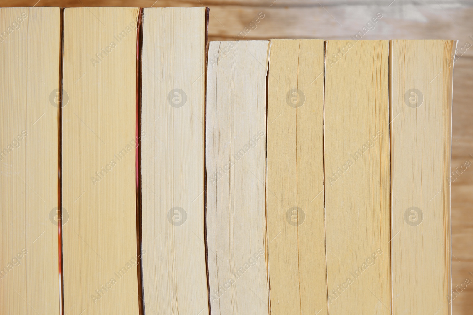 Photo of Collection of different books against wooden background, closeup