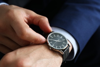 Photo of Businessman in jacket with luxury wrist watch, closeup