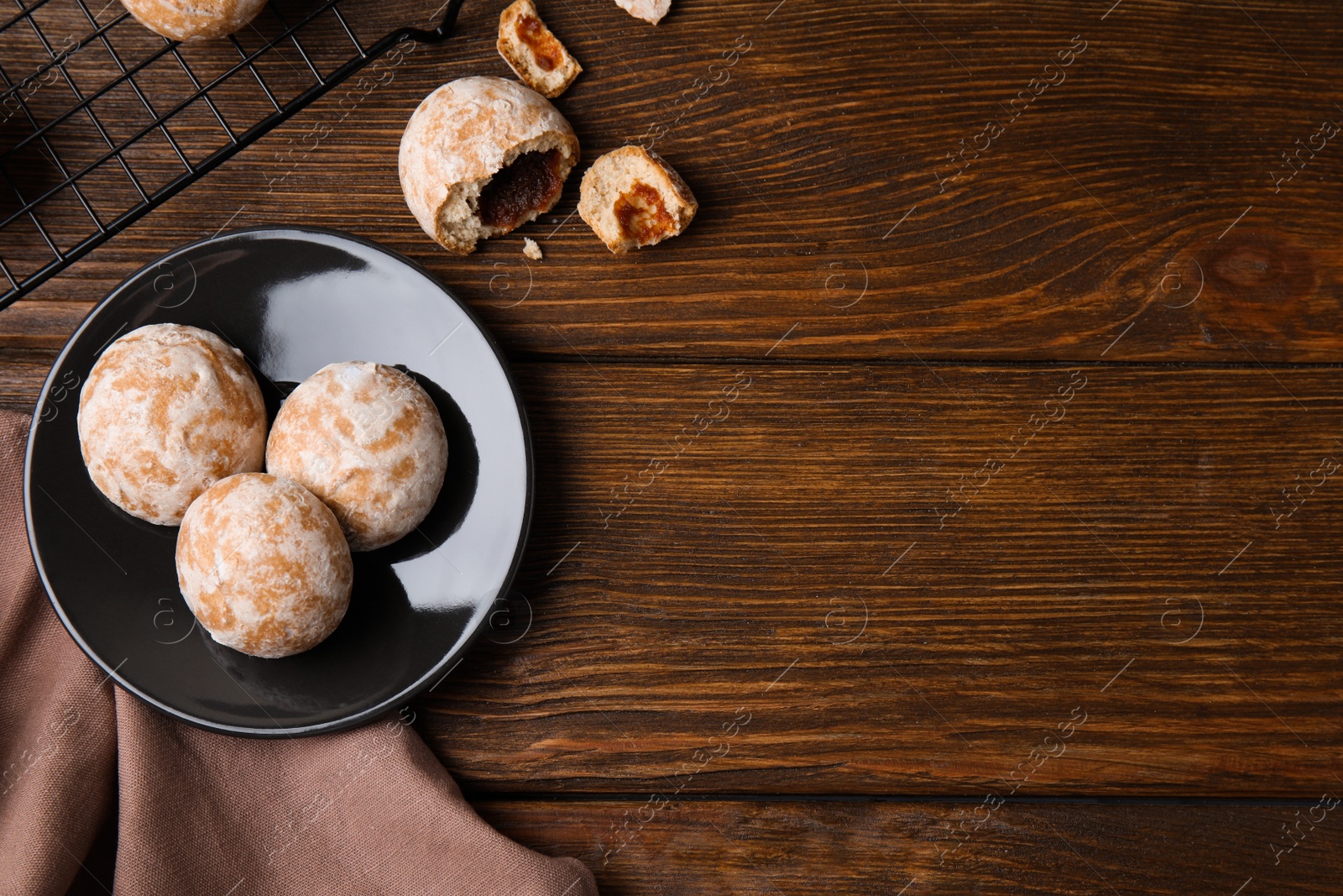 Photo of Tasty homemade gingerbread cookies on wooden table, flat lay. Space for text