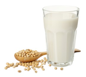 Photo of Glass of fresh soy milk and spoon with beans on white background