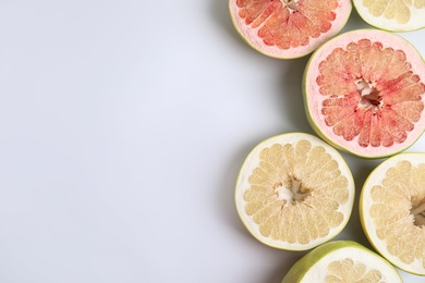 Photo of Fresh cut pomelo fruits on white background, top view