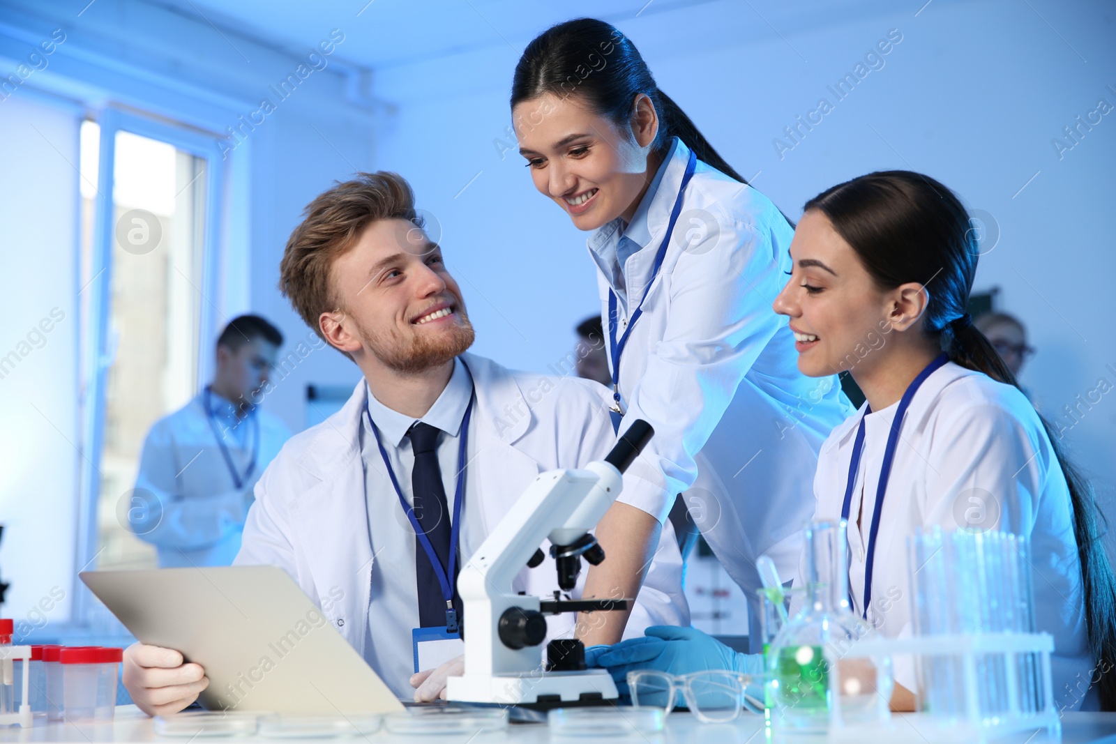 Photo of Group of scientists working in modern chemistry laboratory