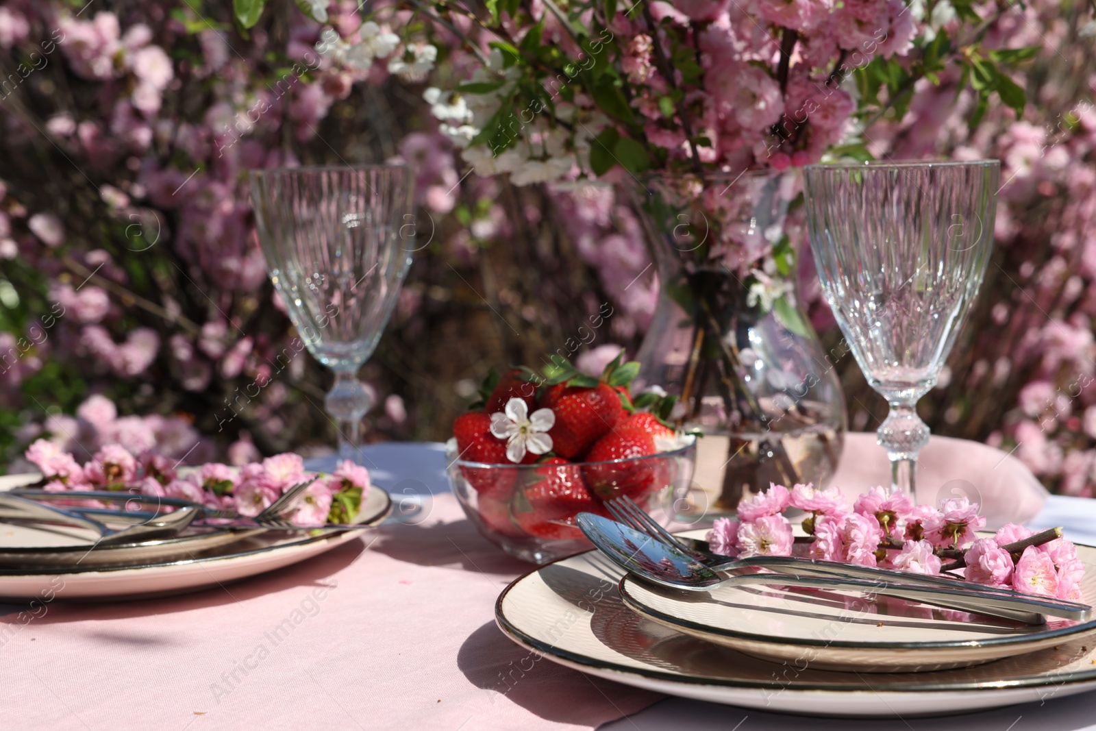 Photo of Stylish table setting with beautiful spring flowers in garden