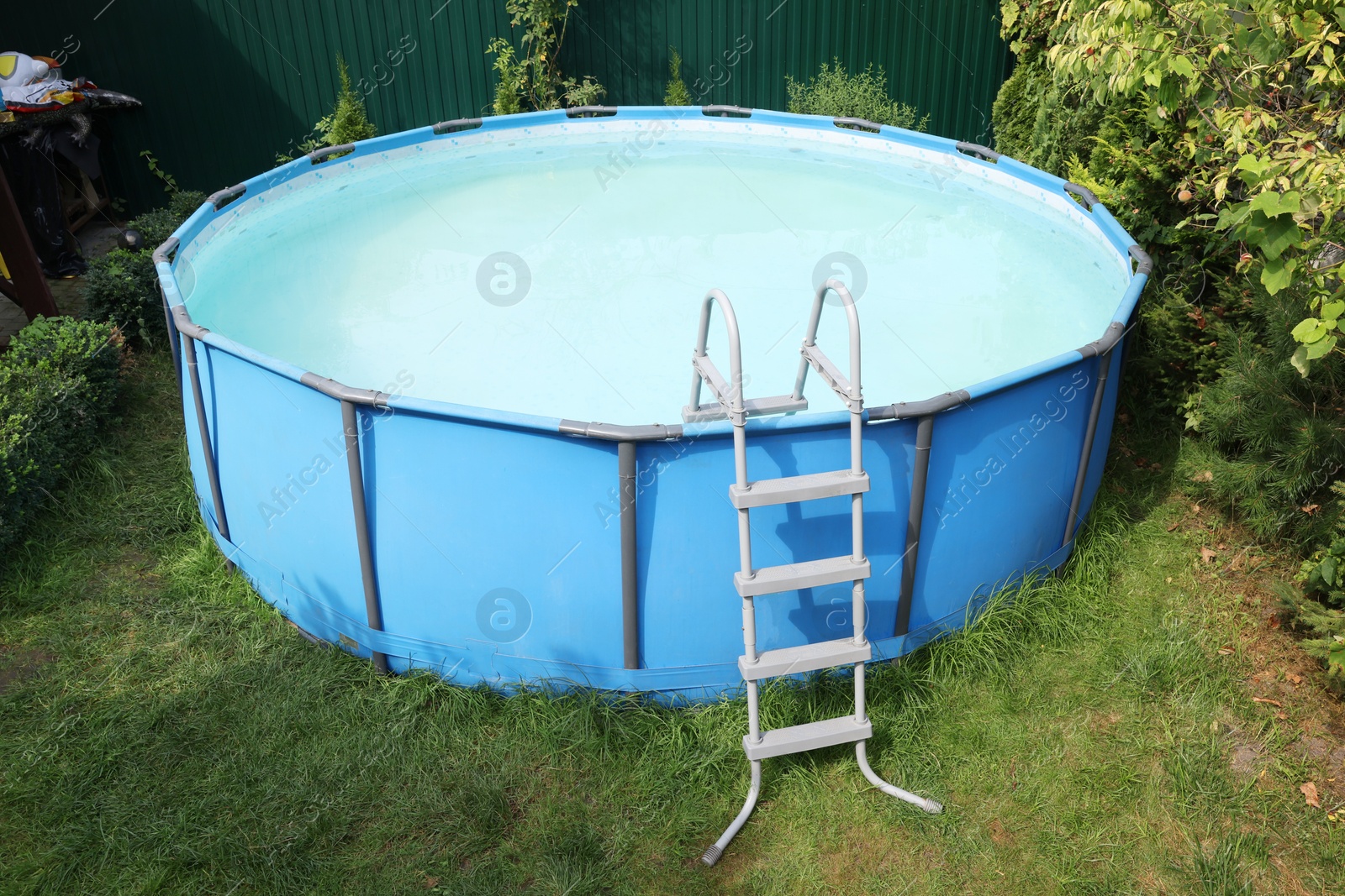 Photo of Above ground swimming pool on grass in backyard