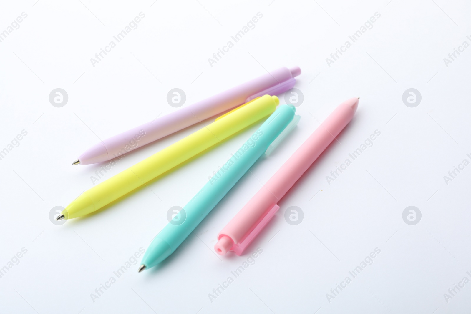 Photo of Set of colorful retractable pens isolated on white