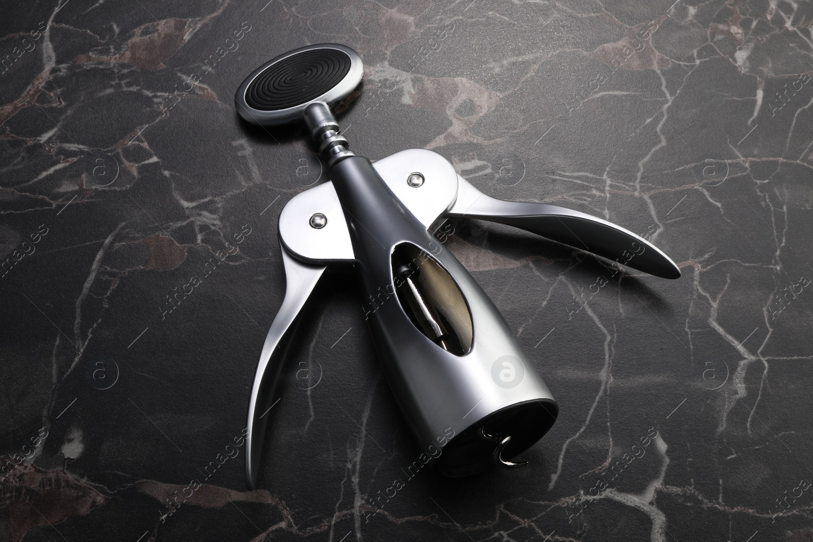 Photo of One wing corkscrew on black marble table
