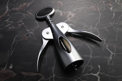 One wing corkscrew on black marble table