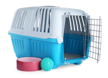 Photo of Light blue pet carrier, bowl and toy isolated on white