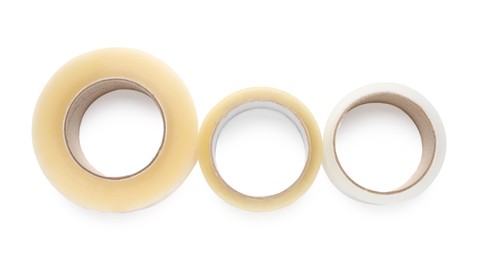 Photo of Rolls of adhesive tape on white background, top view