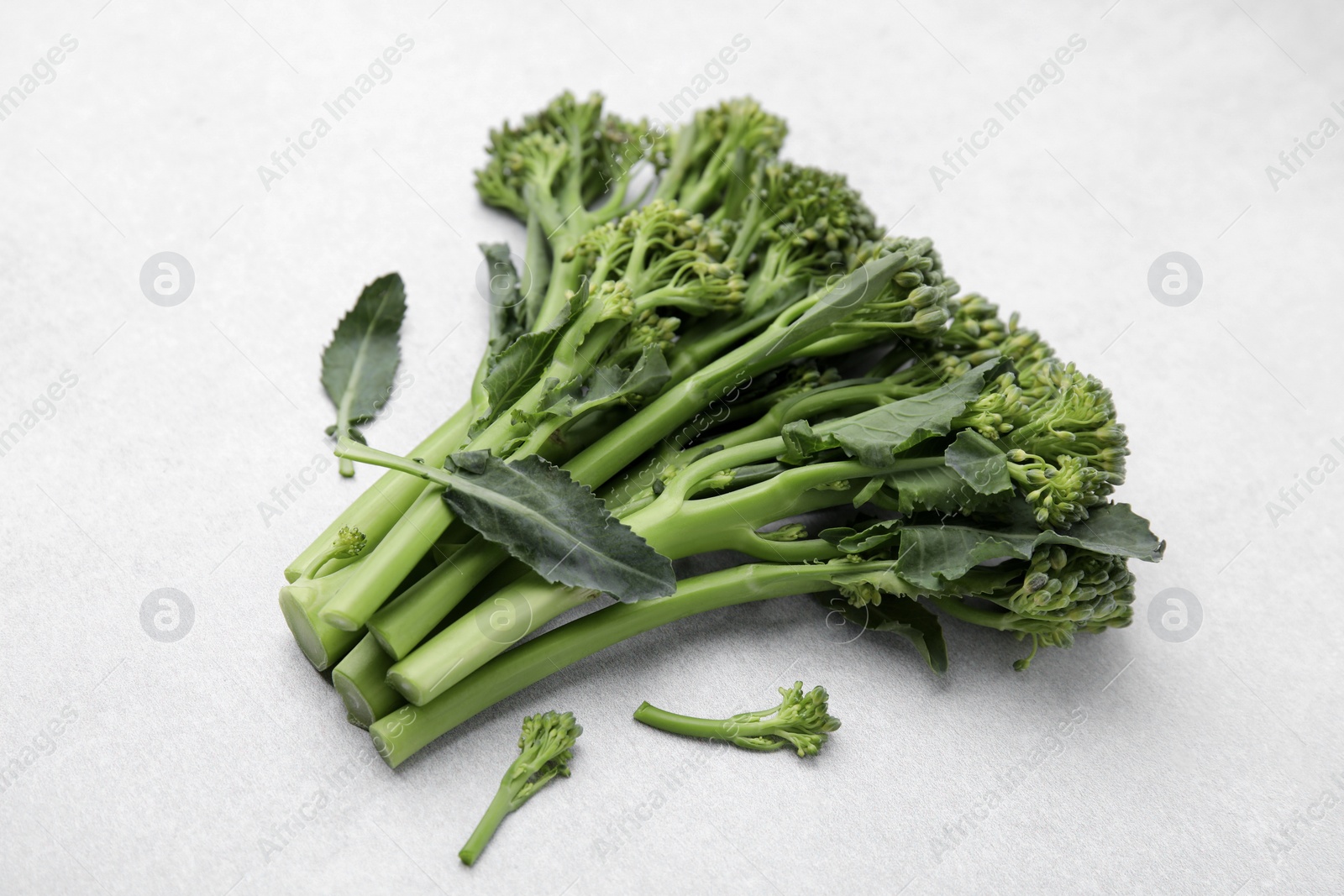 Photo of Fresh raw broccolini on white background. Healthy food