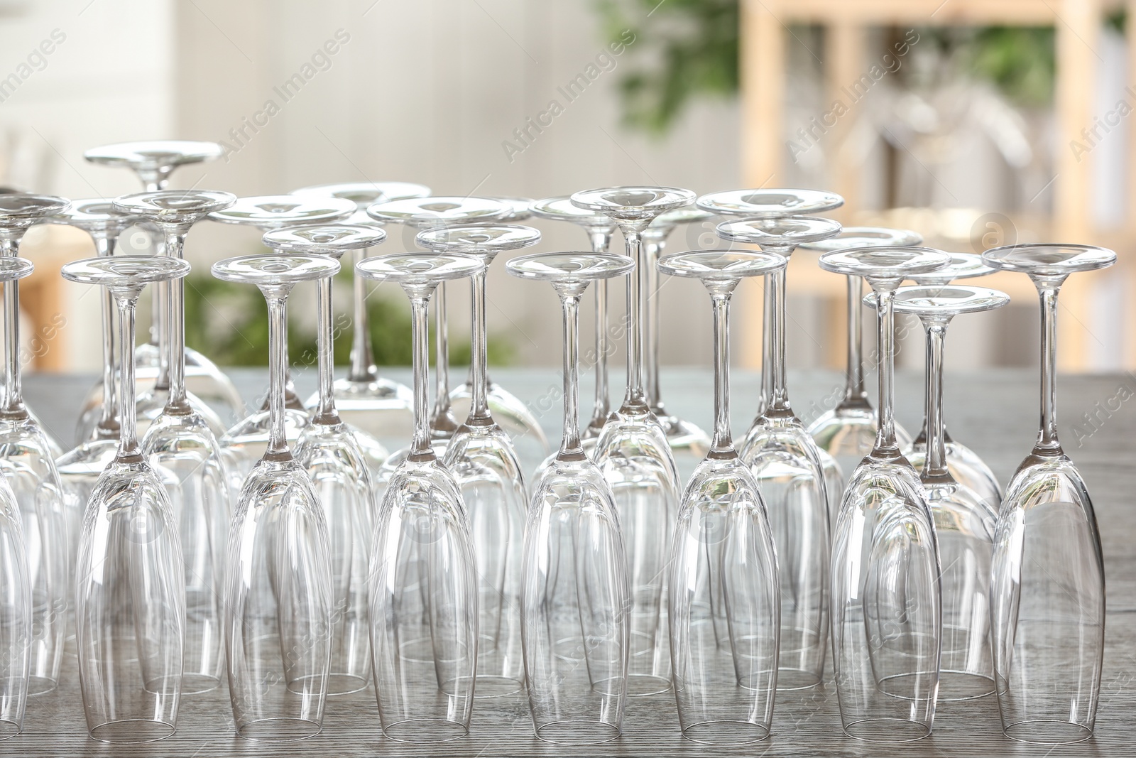 Photo of Empty glasses on wooden table against blurred background