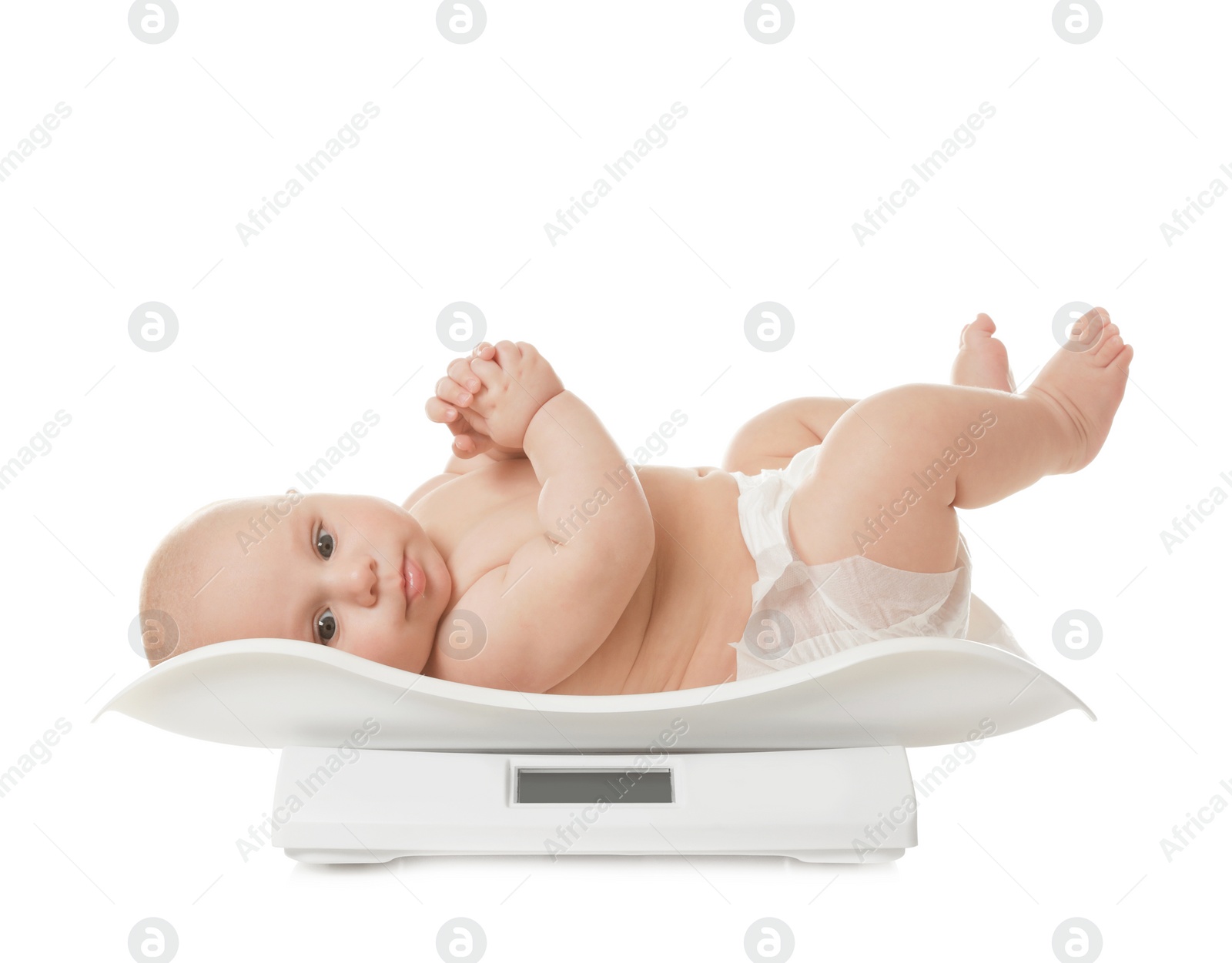 Photo of Cute little baby lying on scales against white background