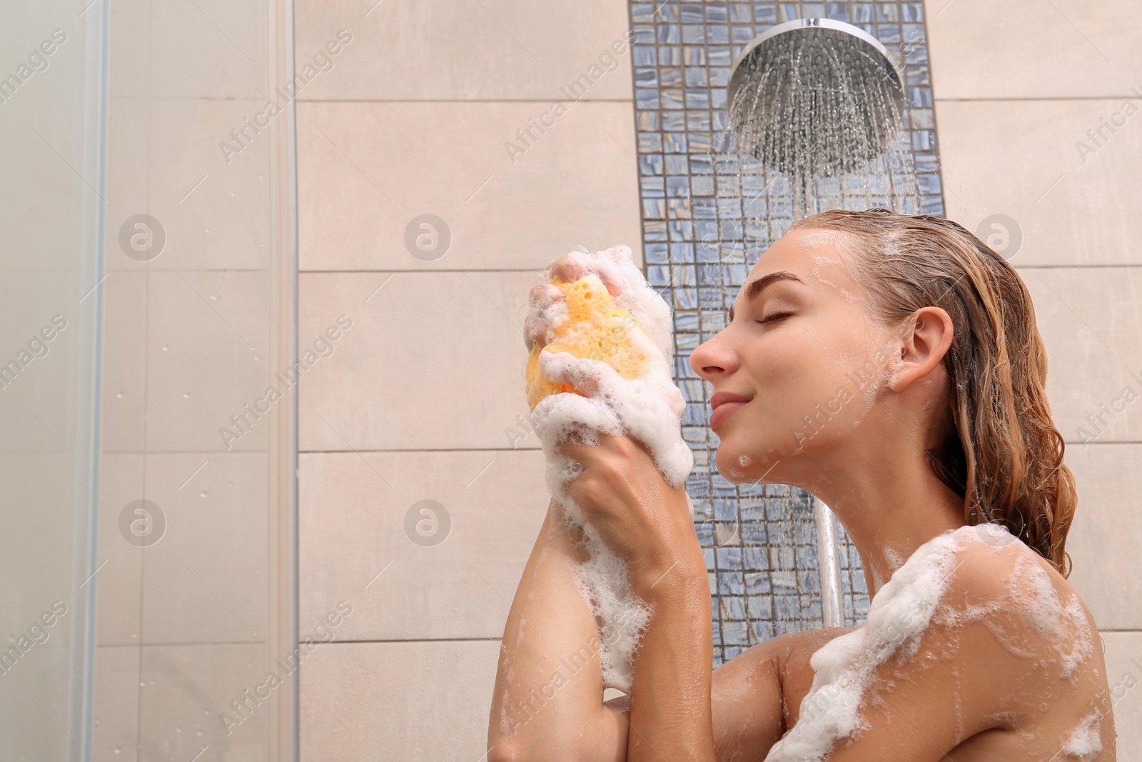 Photo of Beautiful young woman taking shower at home