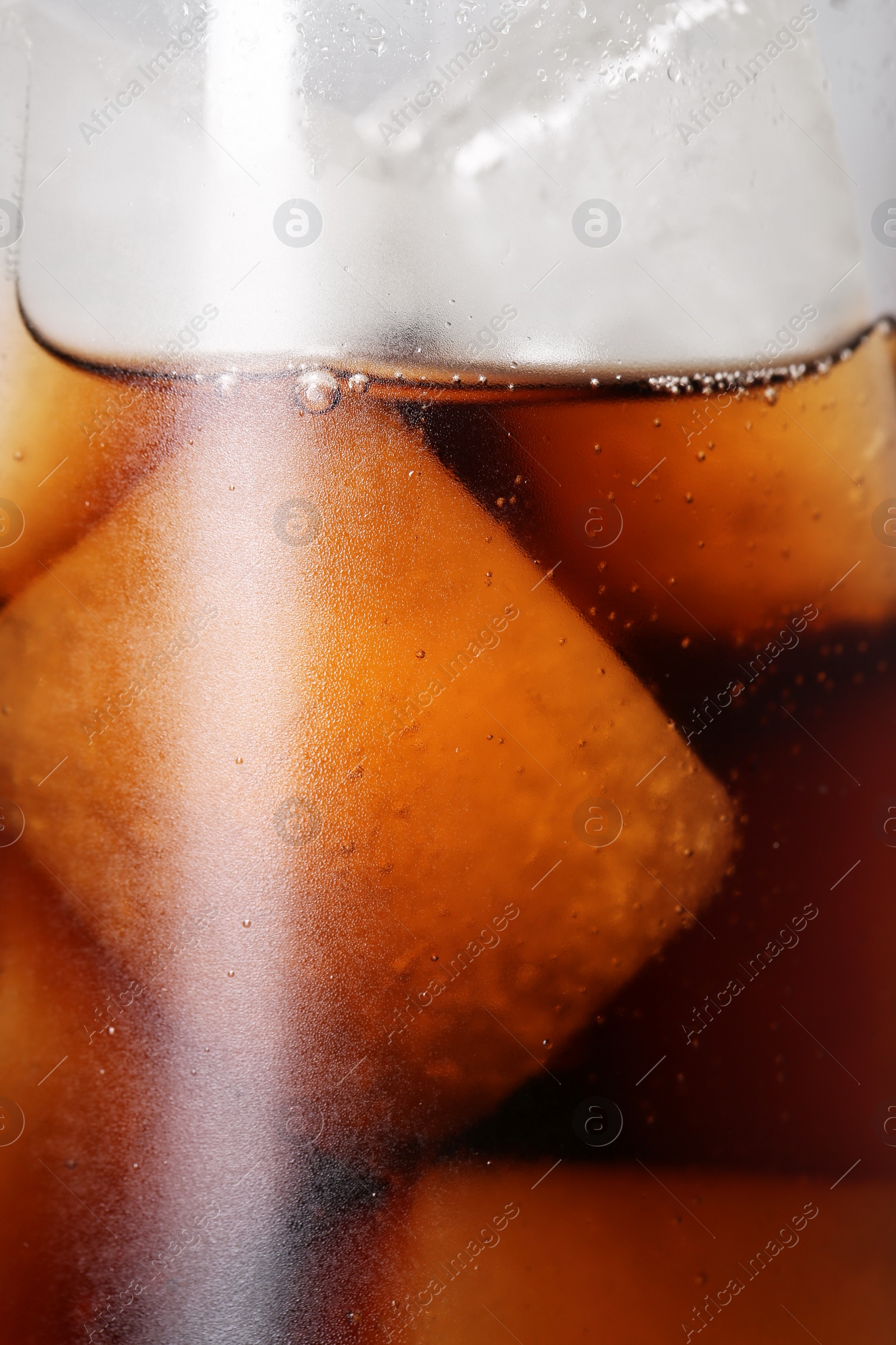 Photo of Glass of refreshing drink with ice cubes as background, closeup