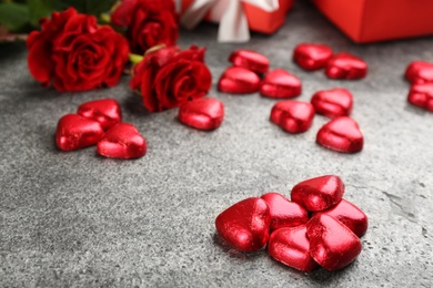 Heart shaped chocolate candies on grey table